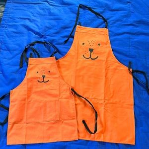 Matching 2-Pack Adjustable Aprons with Pocket. Adult and Child size. Orange